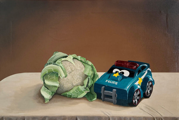Still life with cauliflower and toy